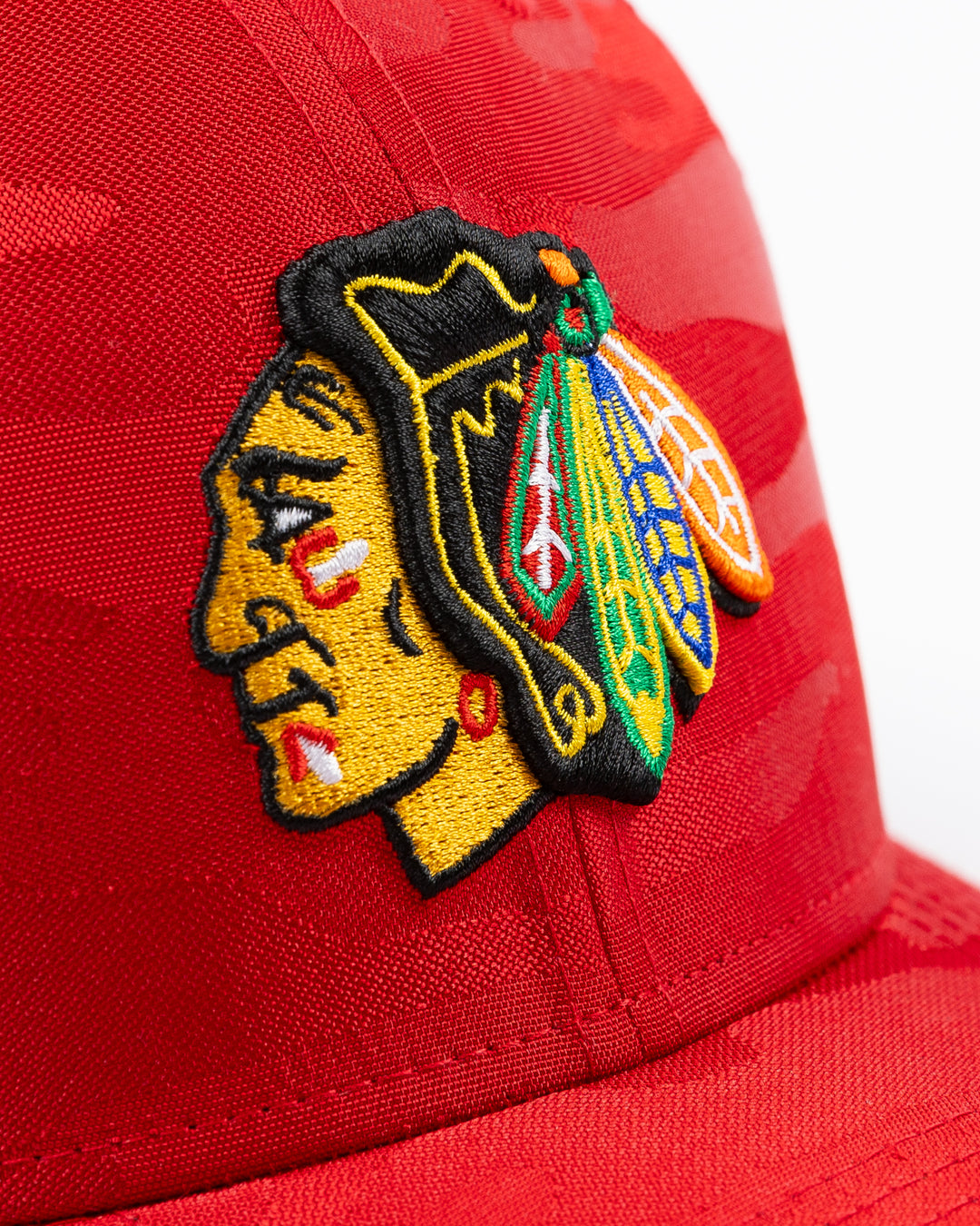 red camo New Era trucker cap with embroidered Chicago Blackhawks primary logo on front - front detail lay flat