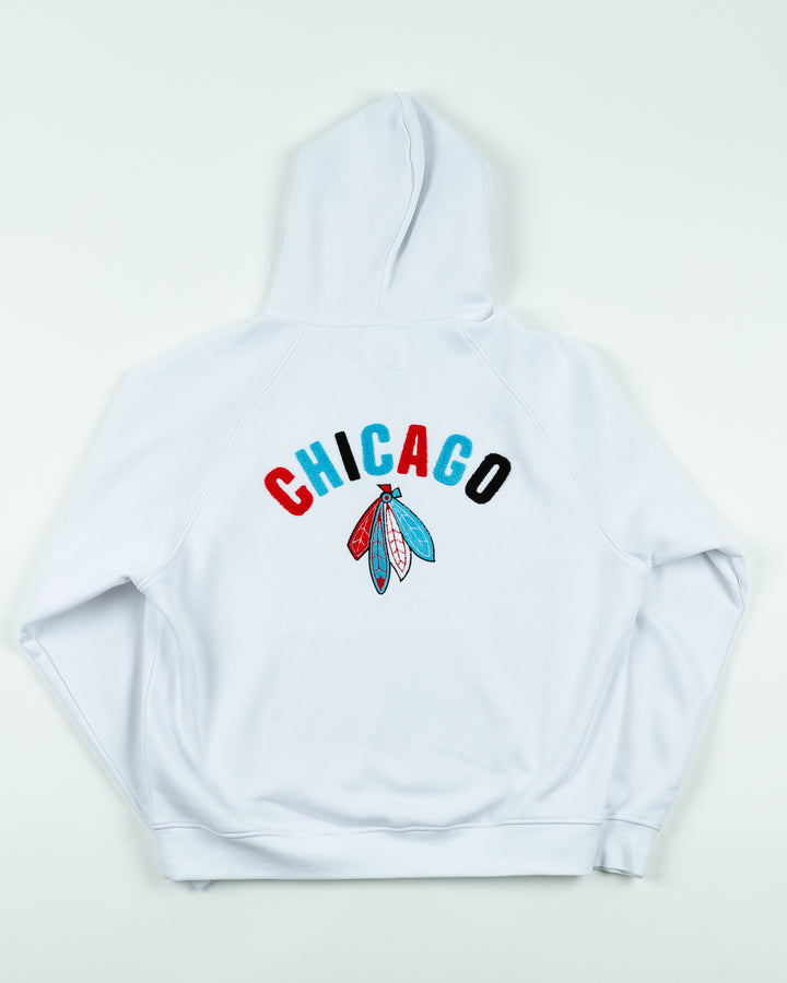 white oversized hoodie with Chicago Blackhawks secondary logo embroidered on front chest and Chicago wordmark and four feathers logo embroidered on back - back lay flat