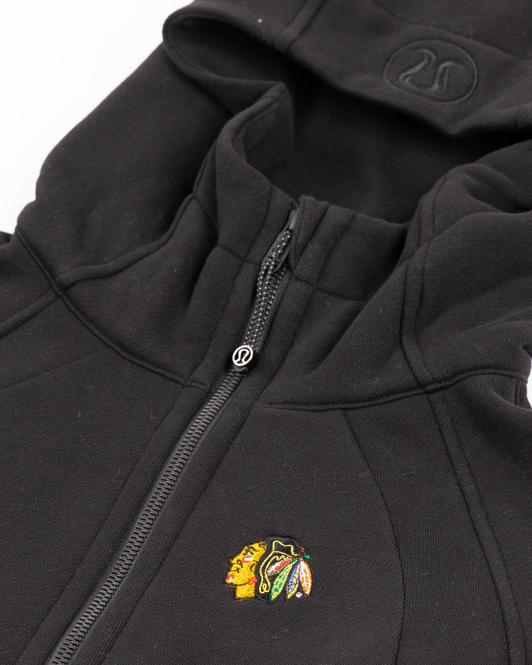 black lululemon scuba full zip women's hoodie with Chicago Blackhawks primary logo embroidered on left chest - front detail lay flat