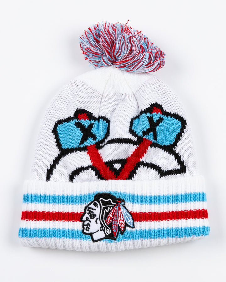 white knit pom hat with Chicago Blackhawks secondary logo on front and primary logo on striped cuff with multi color pom on top in Chicago flag-inspired colorway - front lay flat