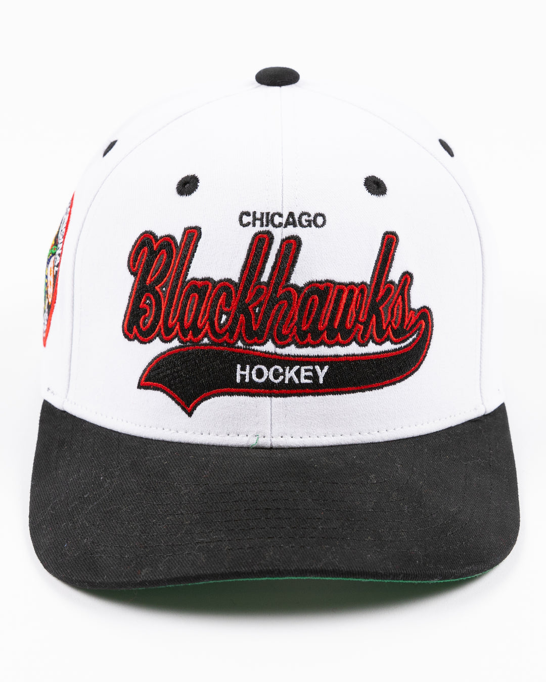 black and white Mitchell & Ness adjustable cap with embroidered Chicago Blackhawks hockey wordmark on front and primary logo on right side - front lay flat