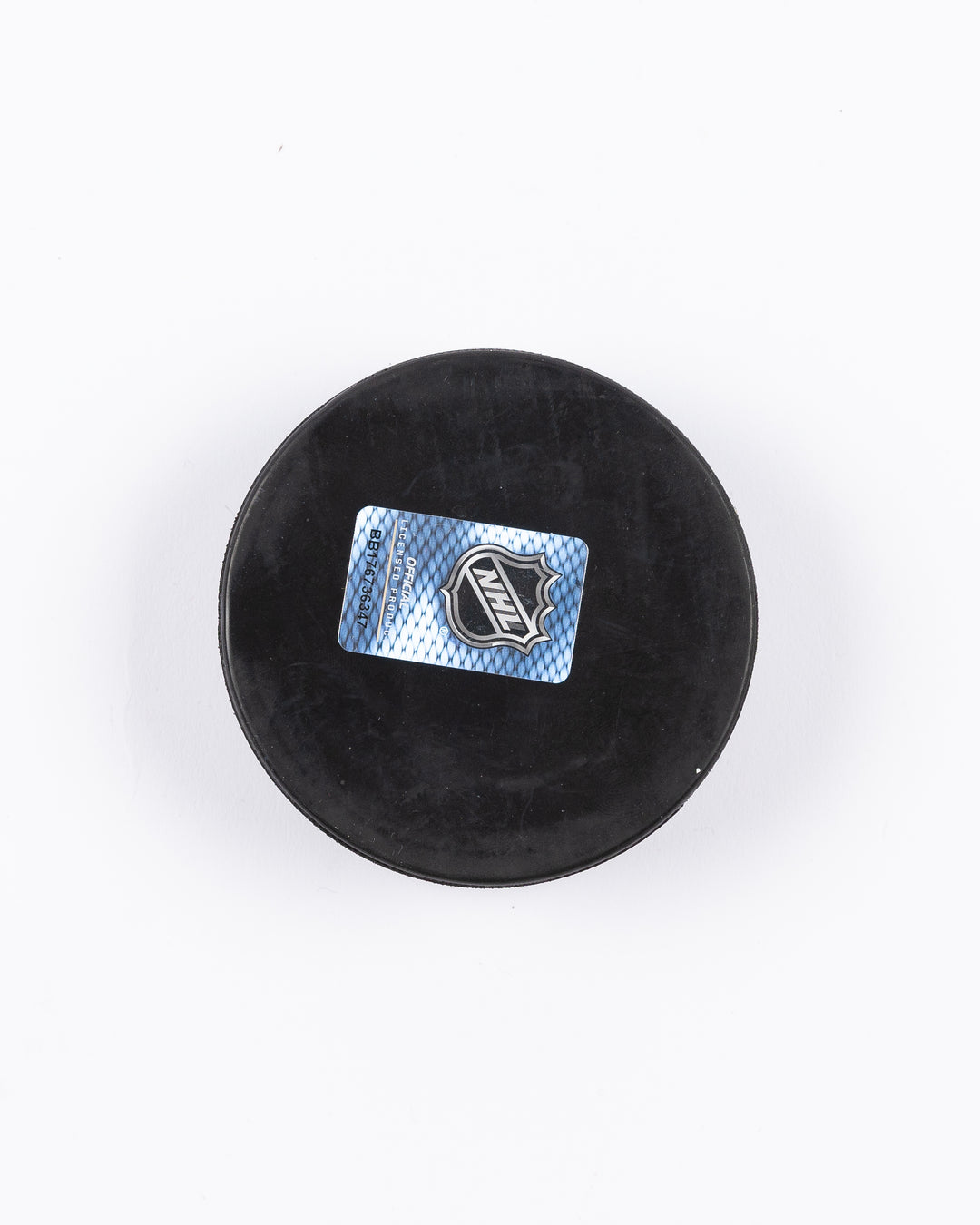 hockey puck with Chicago Blackhawks primary logo and established 1926 word graphic surrounding it - back lay flat