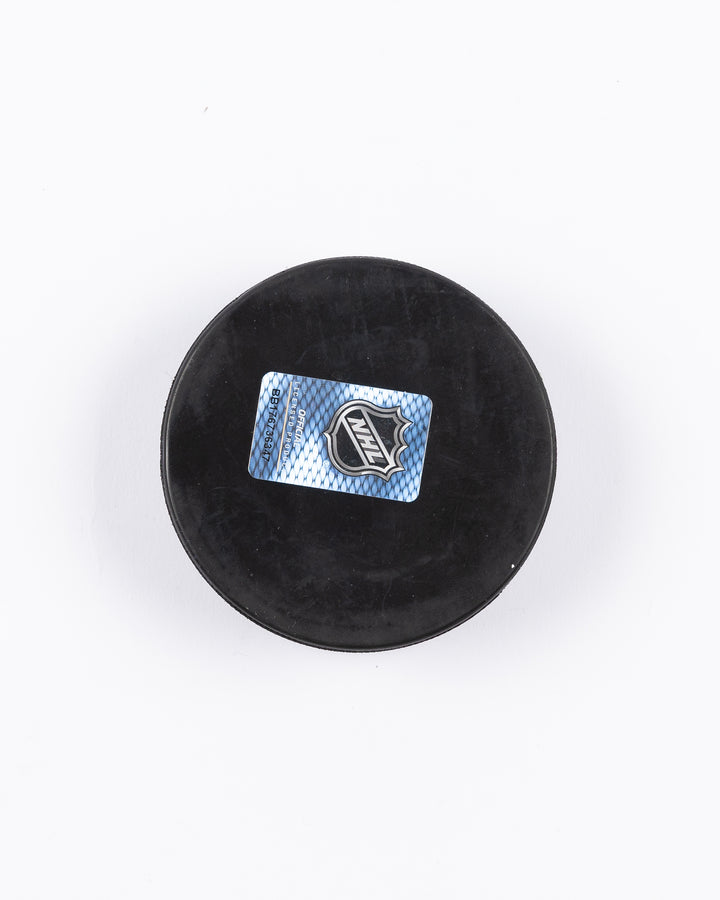 hockey puck with Chicago Blackhawks primary logo and established 1926 word graphic surrounding it - back lay flat