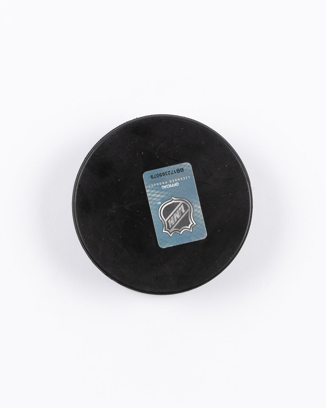 hockey puck with Chicago Blackhawks primary logo and ribbon-inspired design - back lay flat