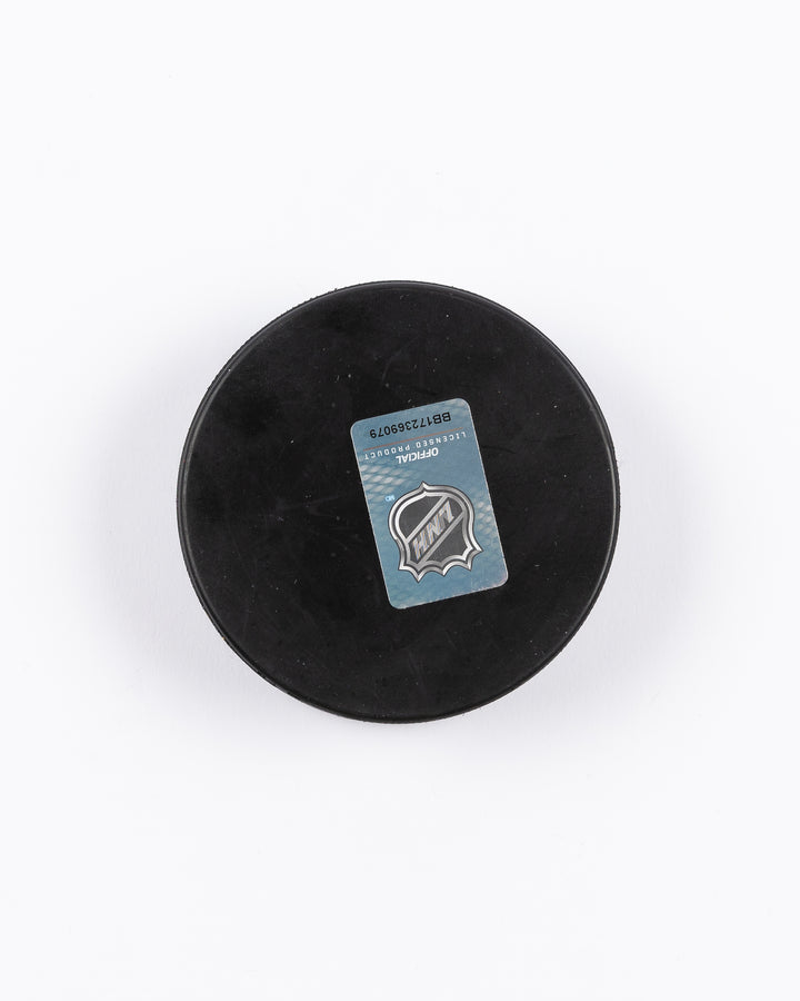 hockey puck with Chicago Blackhawks primary logo and ribbon-inspired design - back lay flat