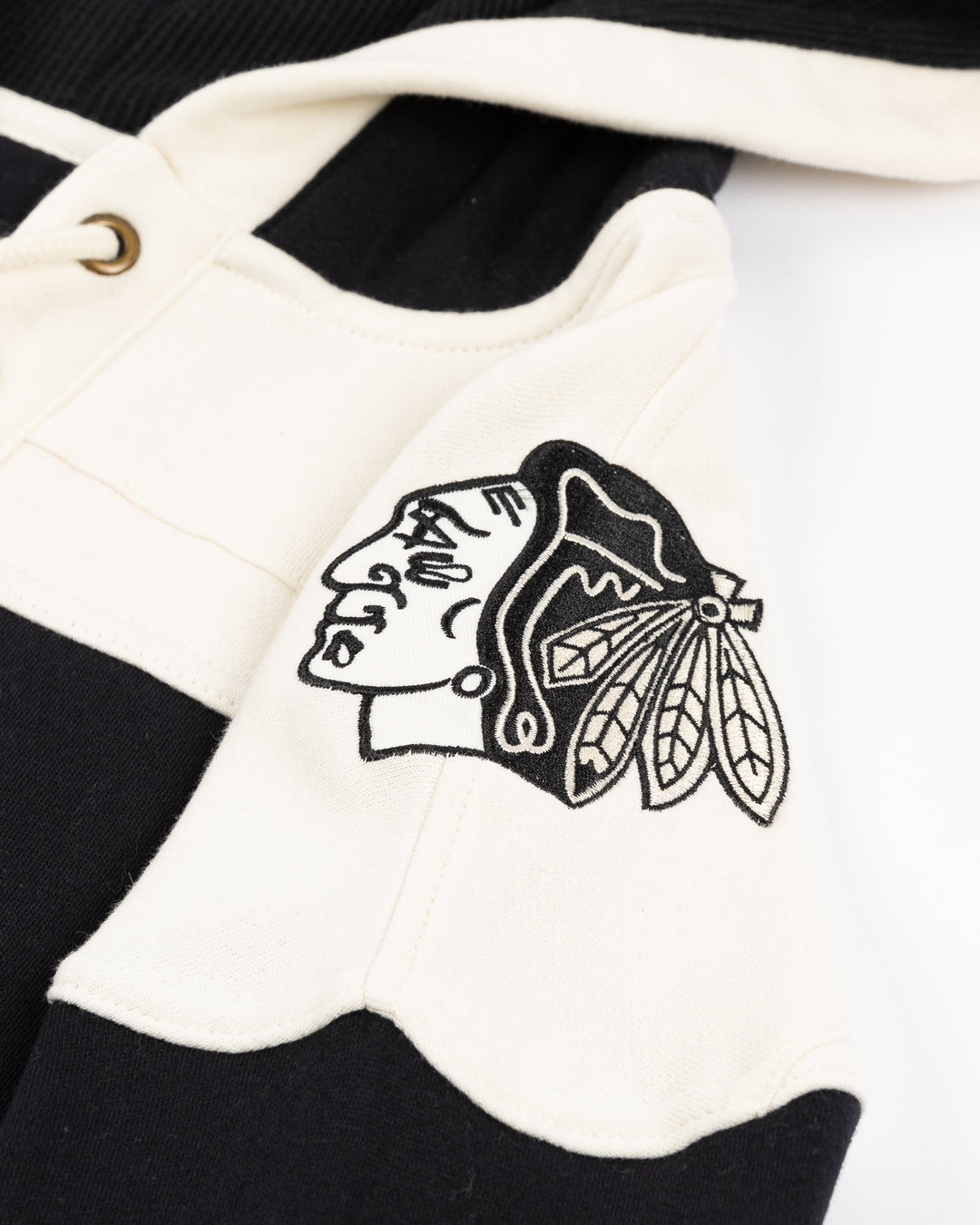 black and cream '47 brand lacer hoodie with Chicago Blackhawks secondary logo on front and primary logo on shoulders - shoulder detail lay flat