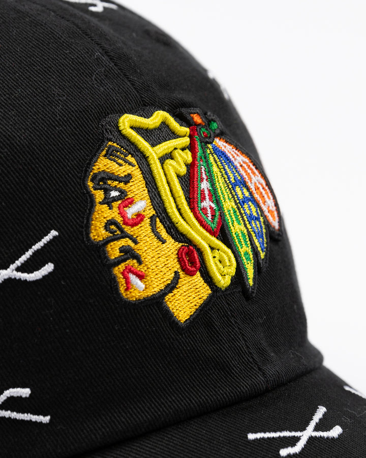 black '47 brand clean up adjustable cap with Chicago Blackhawks primary logo embroidered on front with all over hockey stick pattern - front detail lay flat