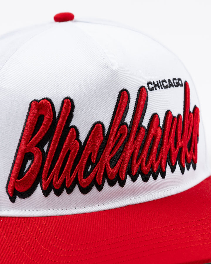 white and red adjustable '47 brand hat with Chicago Blackhawks wordmark embroidered on front and primary logo on right side - front detail lay flat