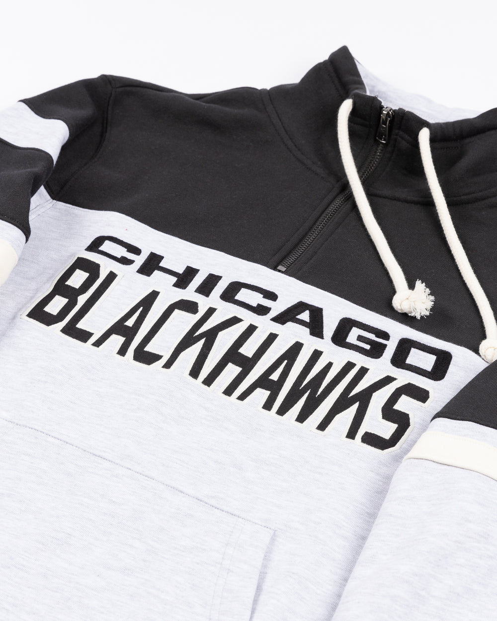 color blocked black and light grey '47 brand quarter zip with Chicago Blackhawks wordmark embroidered on front and primary logo on left shoulder - front detail lay flat