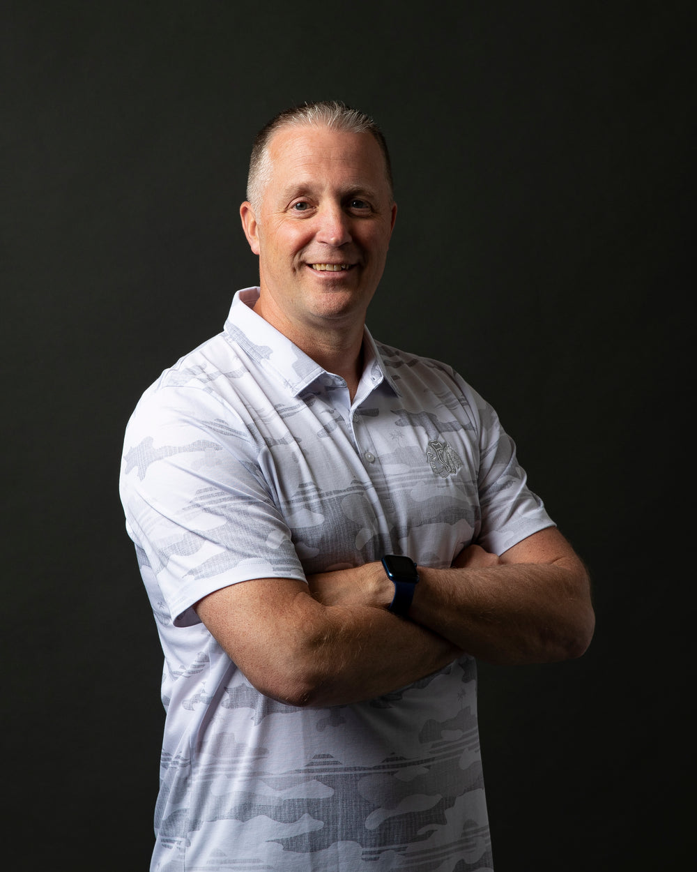 white camo TravisMathew polo with Chicago Blackhawks primary logo embroidered on left chest - on Mike Doneghey Director of Amateur Scouting for the Chicago Blackahawks