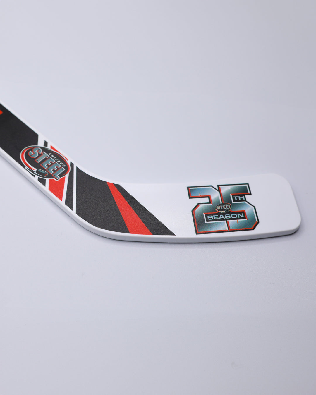 mini hockey stick with Chicago Steel branding and 25th season graphics - front detail lay flat