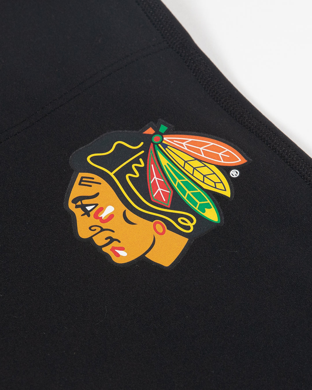 black lululemon women's jogger with full color Chicago Blackhawks primary logo on left leg - detail lay flat