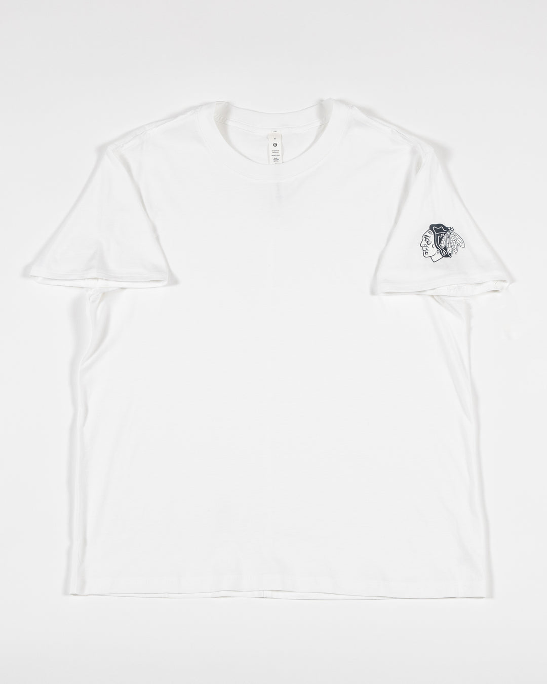 white lululemon tee with Chicago Blackhawks tonal primary logo on left shoulder - front lay flat