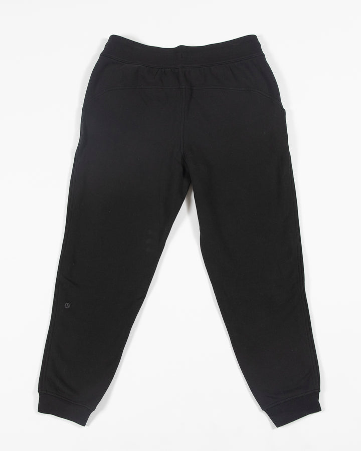 black lululemon joggers with tonal Chicago Blackhawks primary logo embroidered on left leg - back lay flat