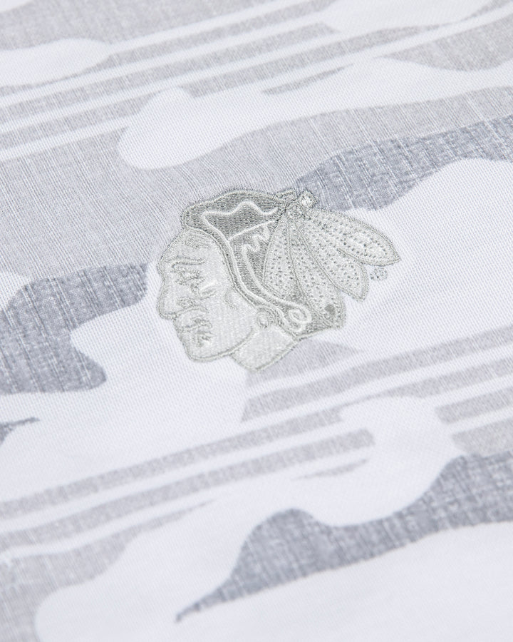 white camo TravisMathew polo with Chicago Blackhawks primary logo embroidered on left chest - detail lay flat